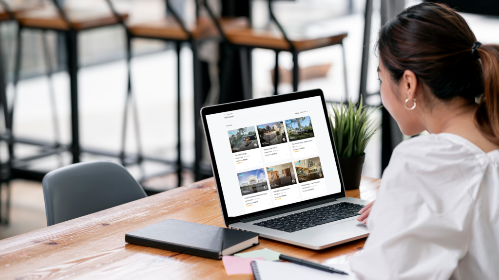 A host researching on laptop the local demand for photoshoot locations, and setting competitive rates.