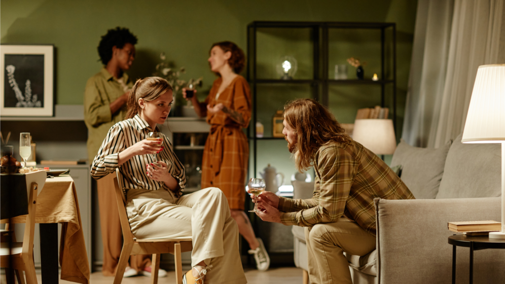 A group of people excitedly discussing a shoot location at an event.