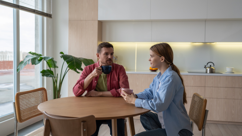 A host discussing feedback with a client at a shoot location.