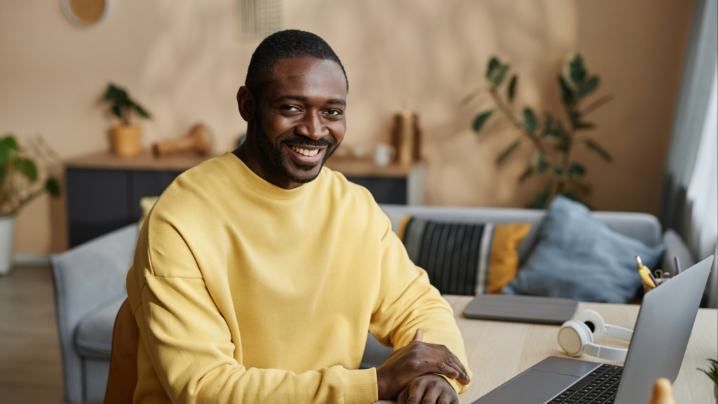 A man handling changes of a shoot location on his laptop.